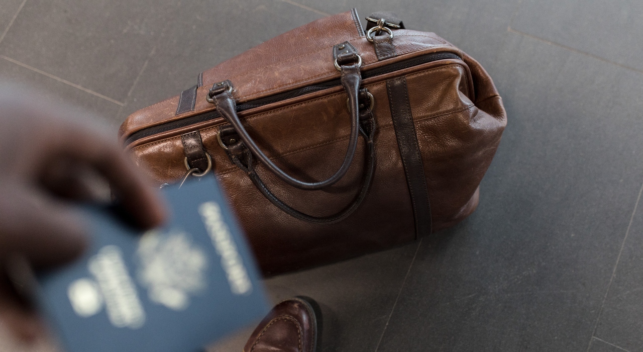 Suitcase and Passport of a WHERE NEXT traveler