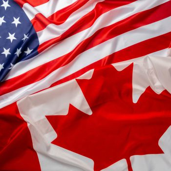 Flags of Canada and USA folded together